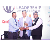 Hughes employees holding dataquest leadership award