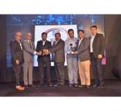 Hughes employees holding ET telecom award